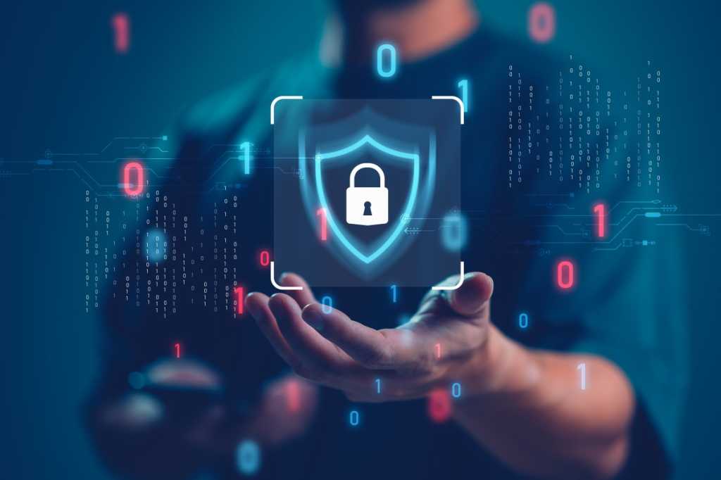 Cisco adds intelligent policy enforcement to mesh firewall family A man holding out his hand, with an icon of a padlock in a shield floating above it.