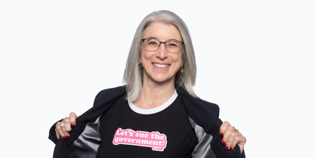 Double Shot of Privacy’s Defender in D.C. Cindy Cohn wearing a t-shirt that says Let's Sue the Government