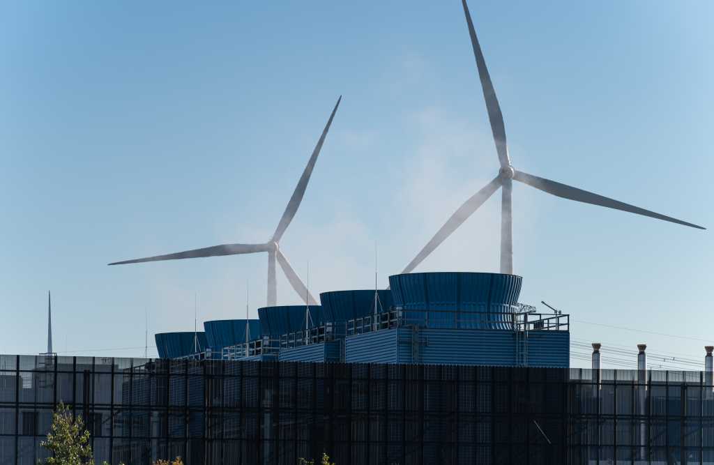 OpenAI puts part of Stargate project on hold over runaway power costs Heat emission from the chimneys of a large data and server complex.